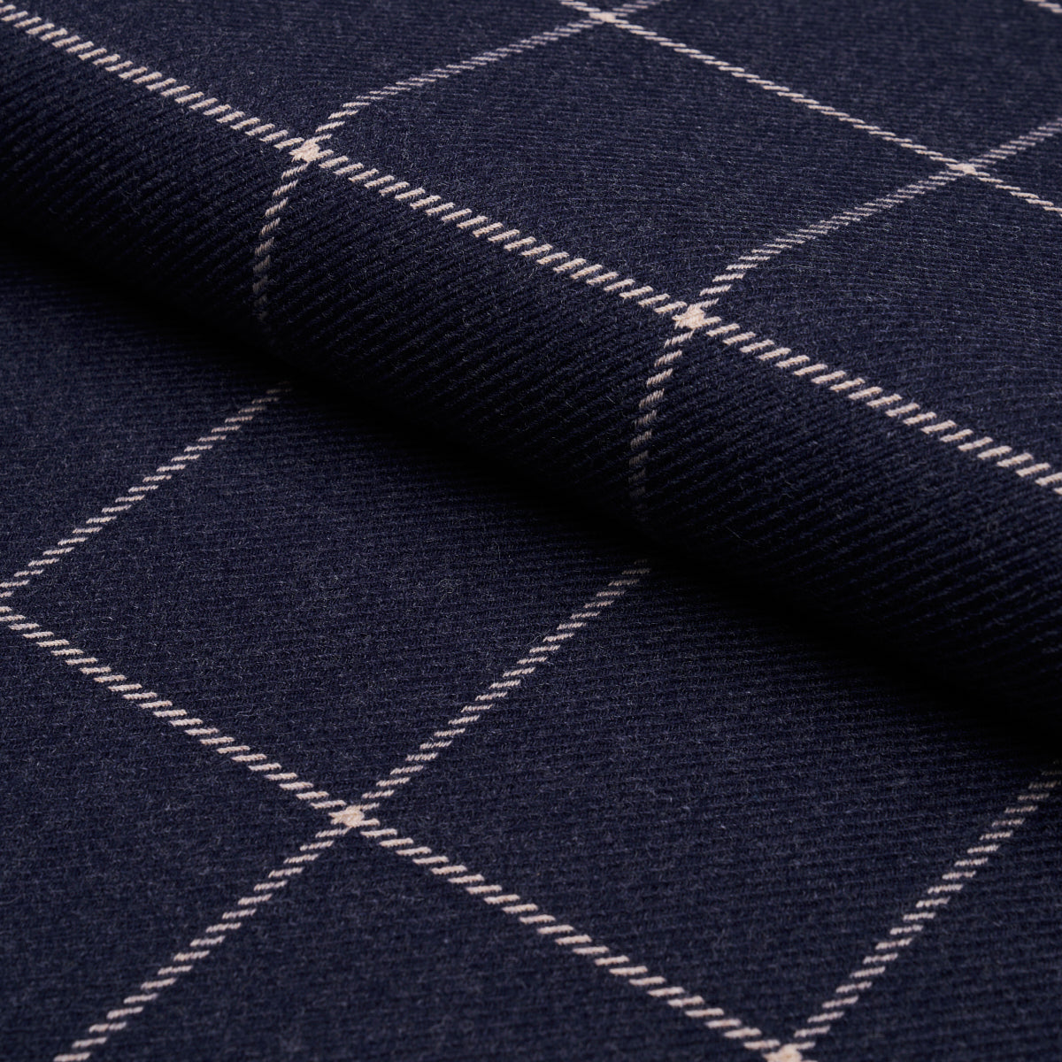 Dark navy fabric with white windowpane grid; folded wool-like textile.