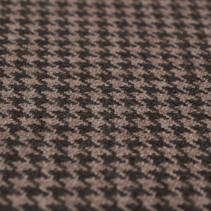 Close-up of brown and beige houndstooth wool fabric with textured weave, ideal for suits and coats.