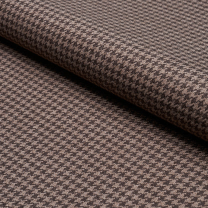Brown and tan houndstooth fabric, folded, wool-like texture.