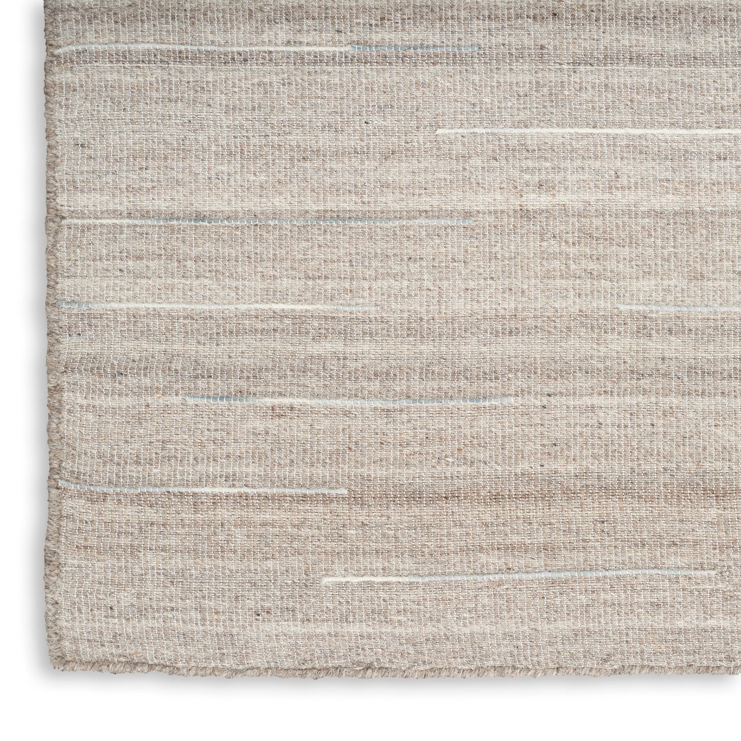 Beige woven rug close-up; natural fiber texture with subtle horizontal cream stripes.