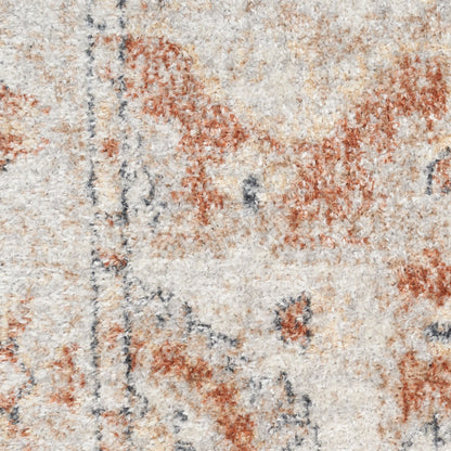 Textured cream area rug with rust-orange floral motifs and blue-gray accents in a distressed pattern.