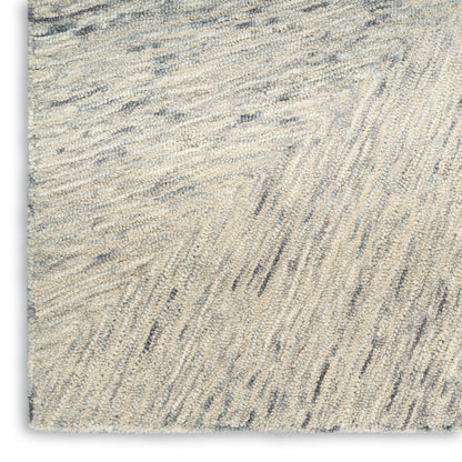 Cream and blue-gray shag rug with subtle chevron pattern and plush textured pile.