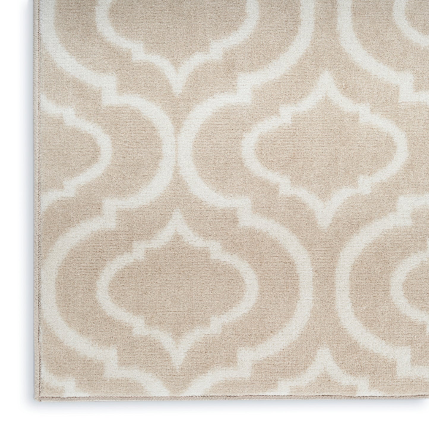 Beige woven rug with cream arabesque trellis pattern; soft textured, rectangular living-room accent.