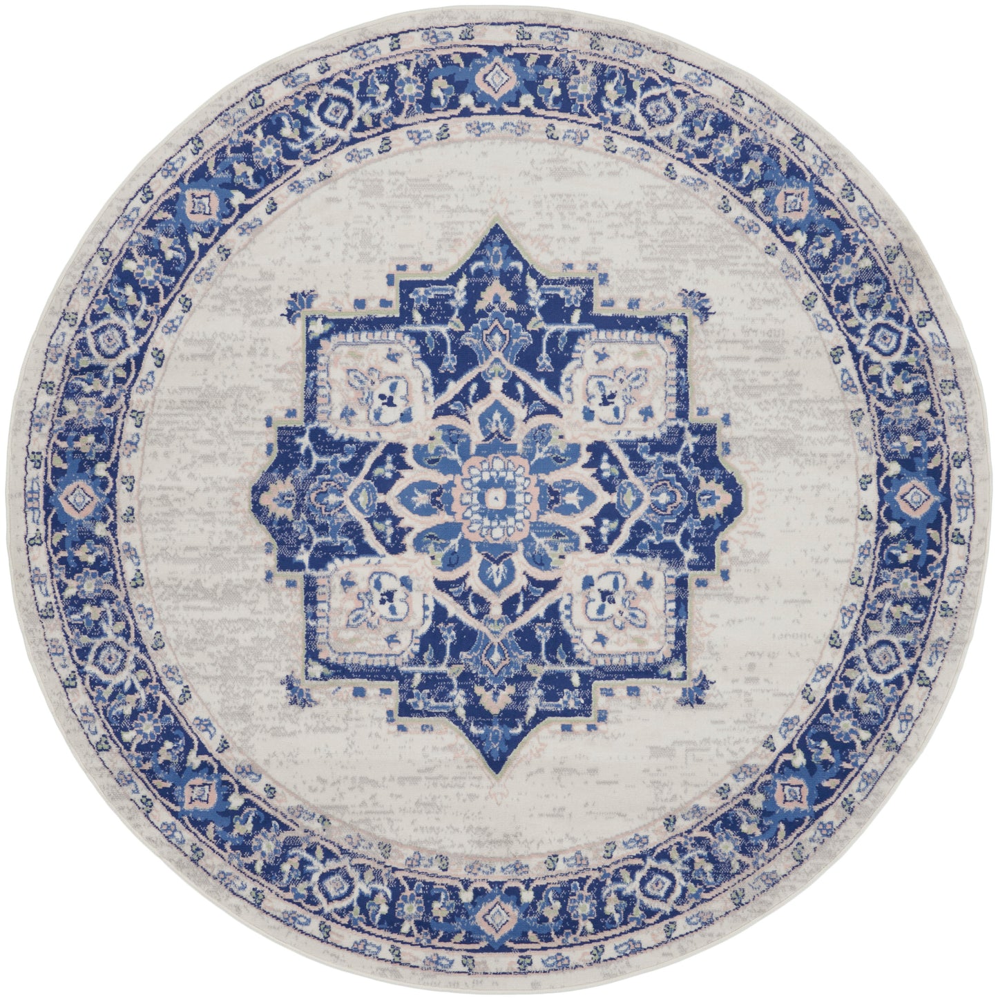 Round blue and ivory rug with Persian-inspired medallion, distressed vintage look, ideal for living room decor.
