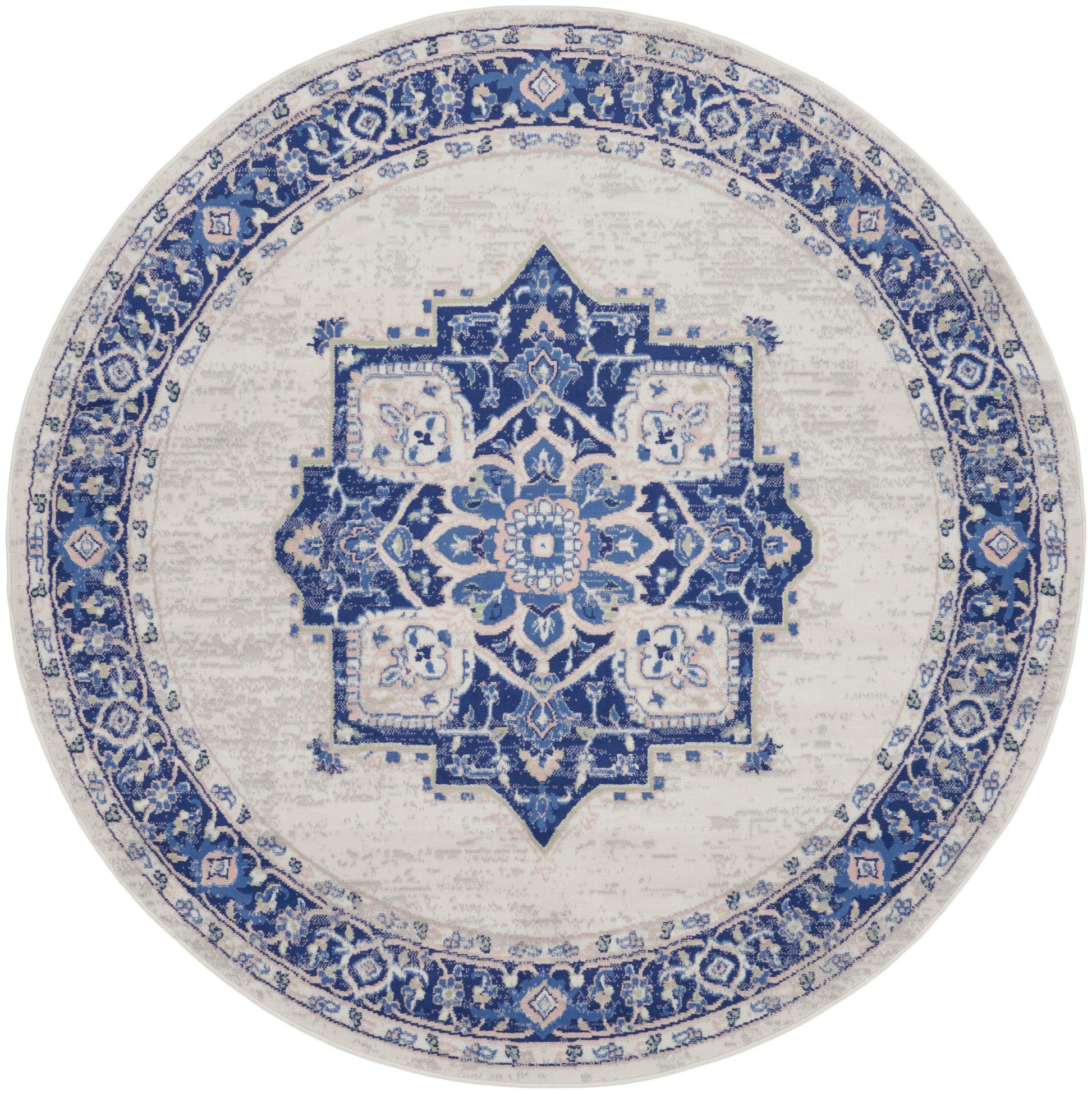 Round blue and ivory rug with Persian-inspired medallion, distressed vintage look, ideal for living room decor.