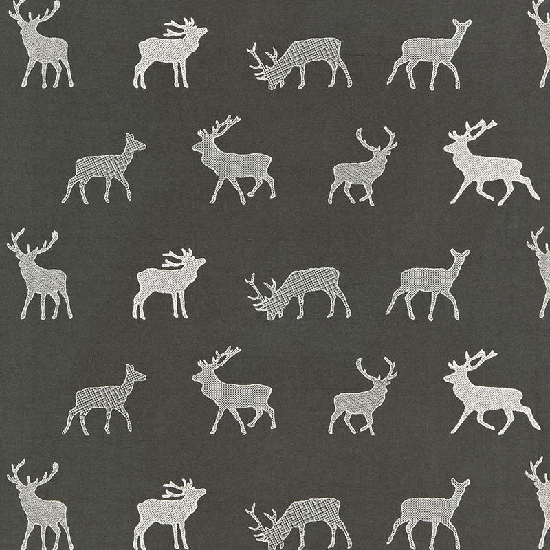 Dark gray textile with white reindeer silhouettes in a repeating pattern.