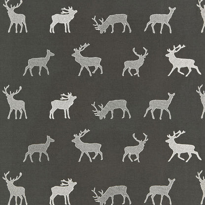 Dark gray textile with white reindeer silhouettes in a repeating pattern.
