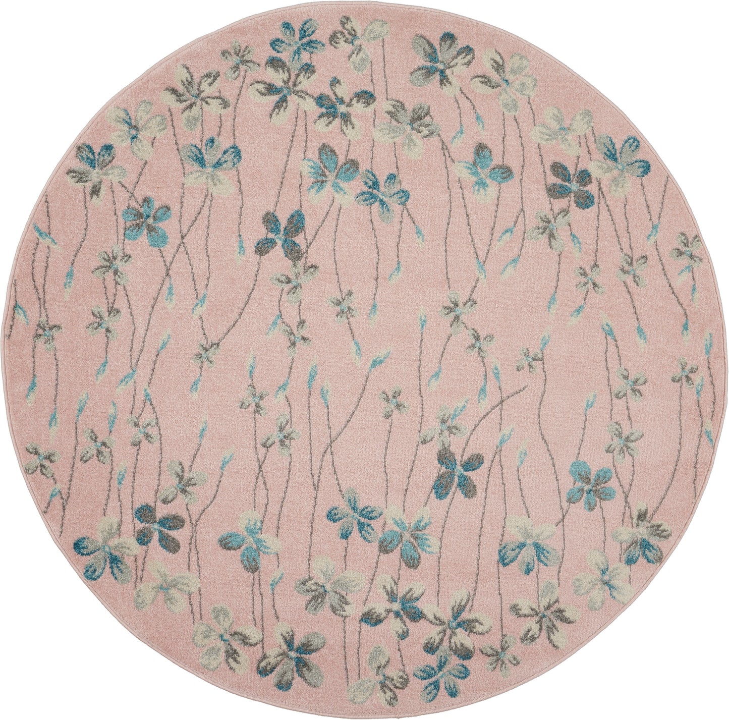 Round pink tufted rug with blue-green floral vines and small blossoms.