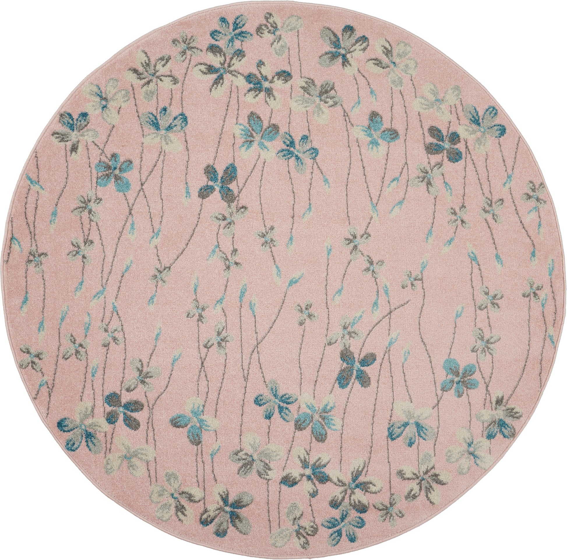 Round pink tufted rug with blue-green floral vines and small blossoms.