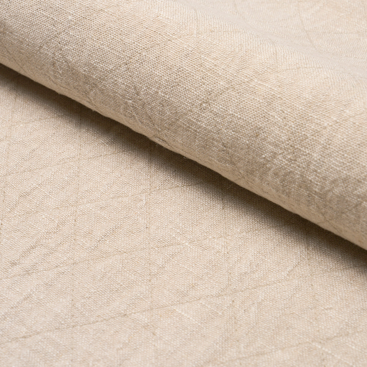 Beige linen-like fabric roll with subtle curved stitch pattern; soft, textured upholstery material.