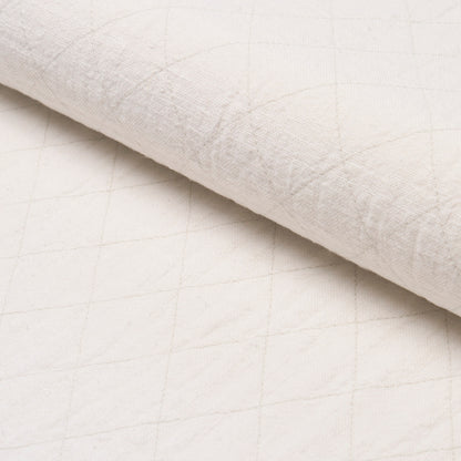 Cream quilted fabric with a subtle diamond pattern, rolled edge.