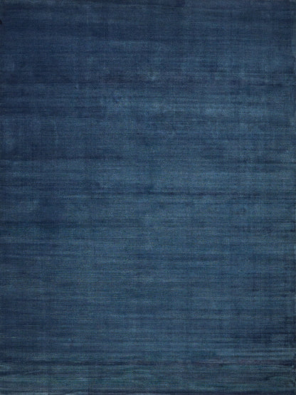 Blue textured area rug with navy and indigo tones and subtle distressed weave.