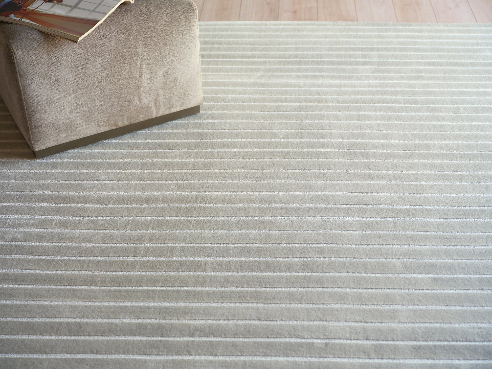 Beige striped plush rug with light cream stripes.