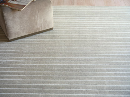 Beige striped plush rug with light cream stripes.