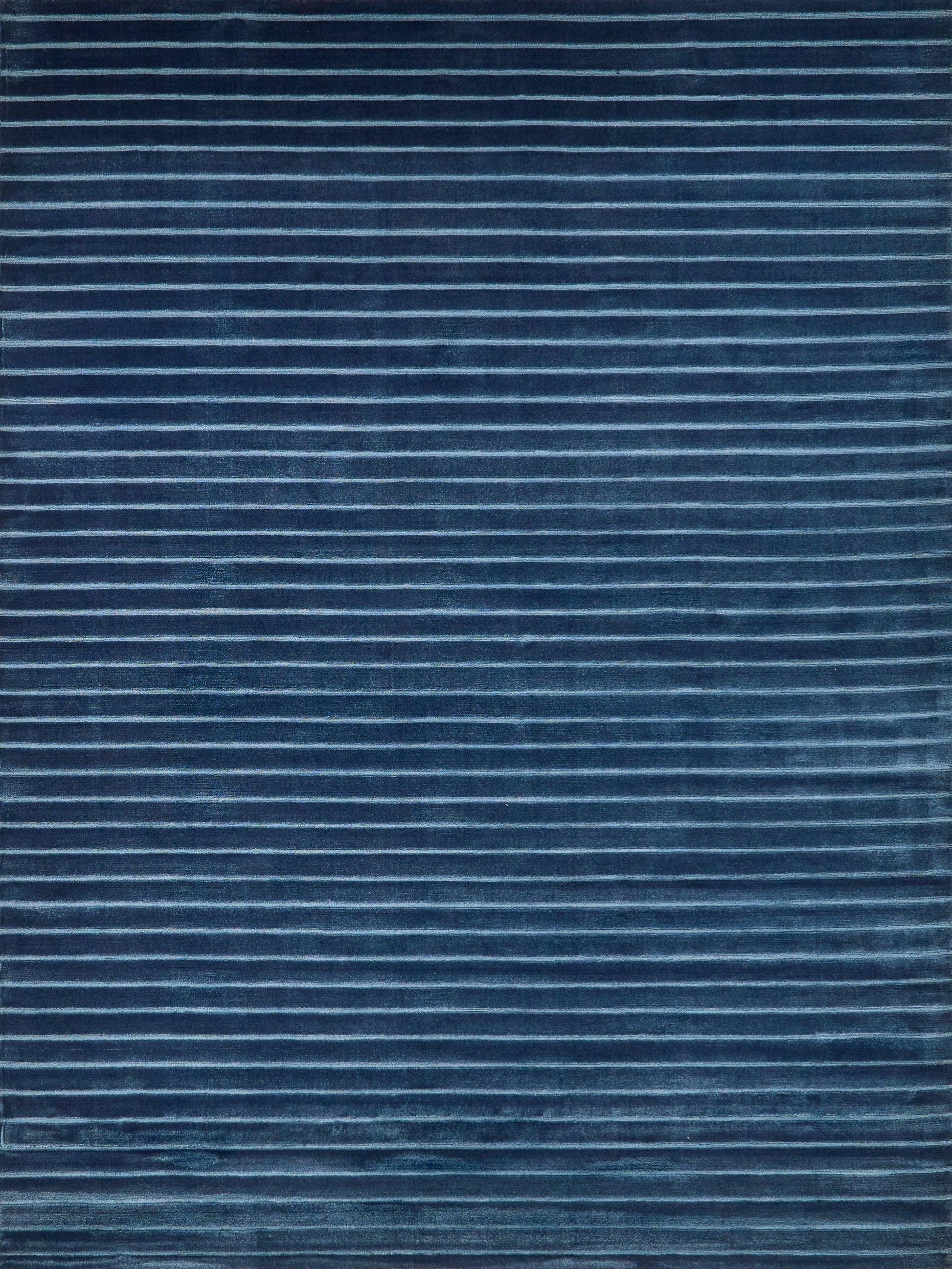 Navy blue rug with thin light-blue horizontal stripes and soft woven texture