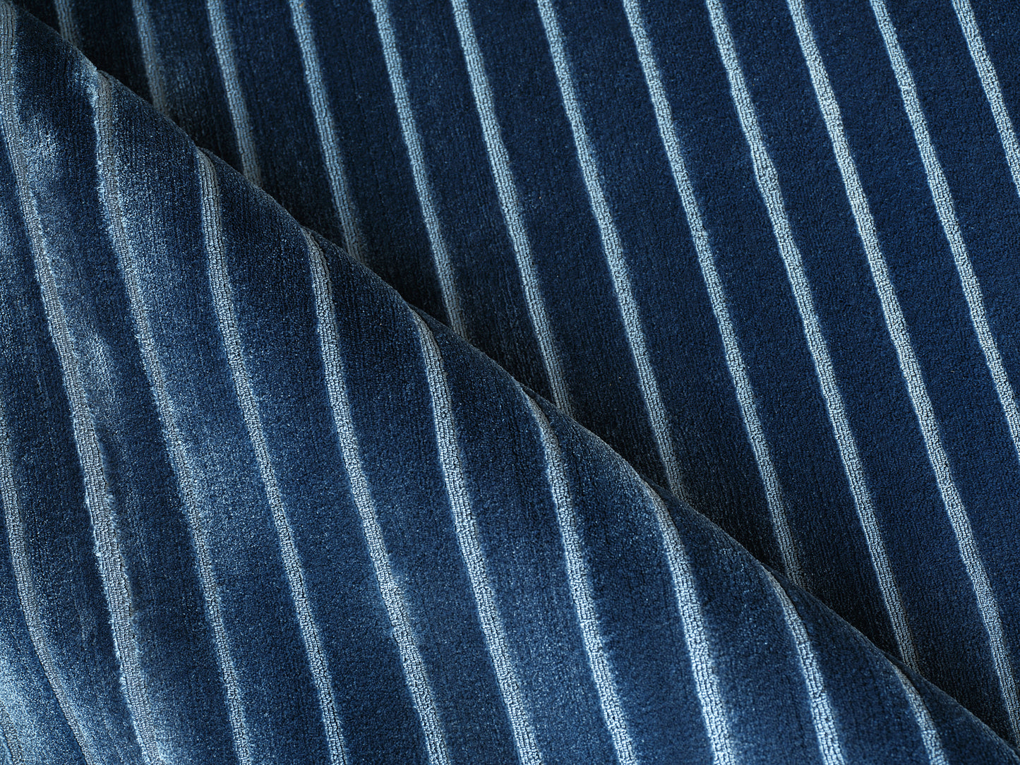 Dark navy velvet rug with light blue vertical stripes; plush texture, 2' x 3'.