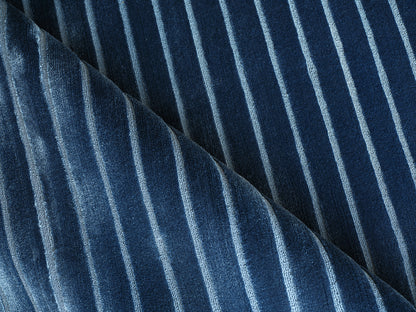 Blue velvet rug with light vertical stripes and soft nap.