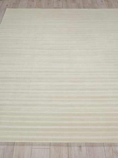 Cream flat-weave rug with subtle horizontal stripes on a light wooden floor.