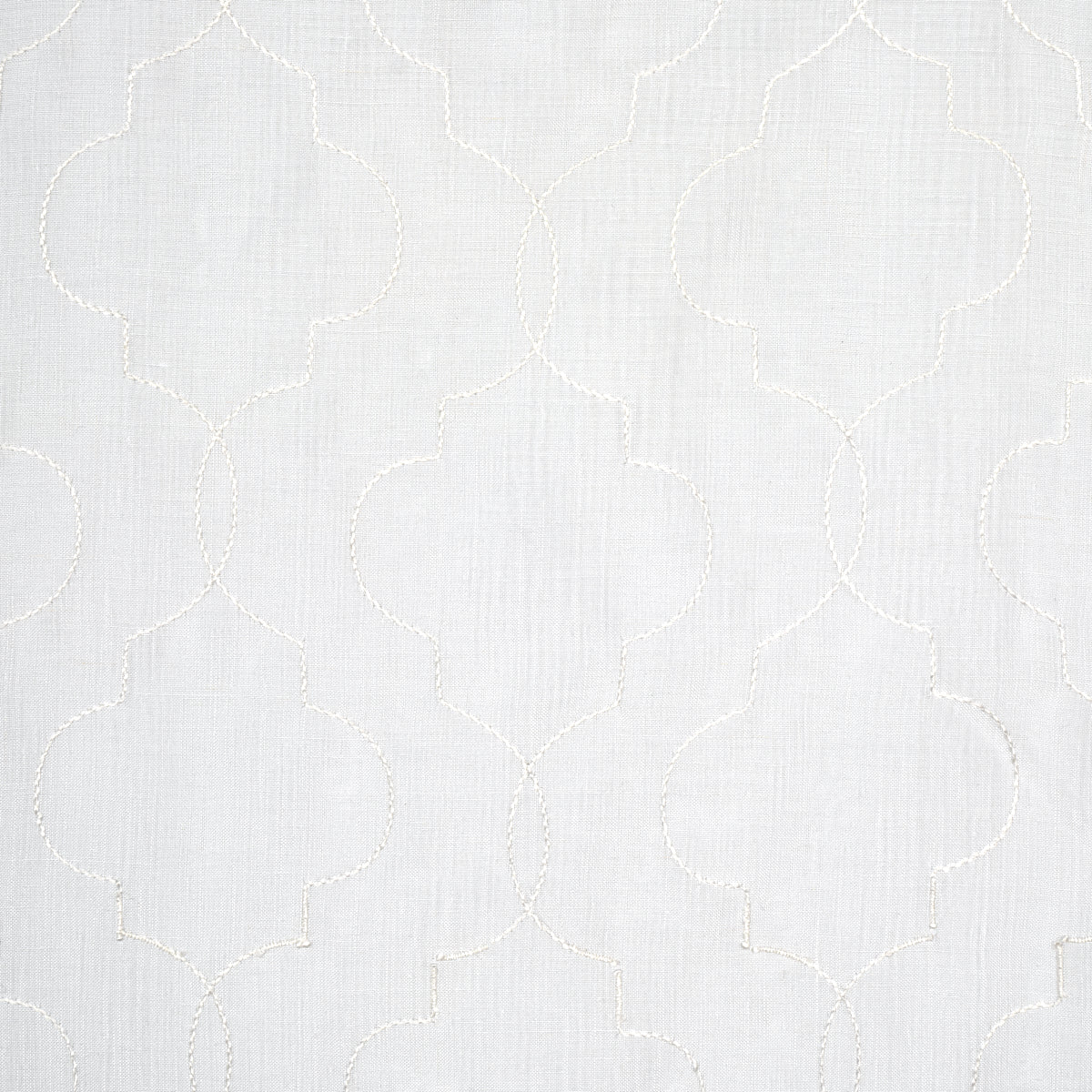 Light gray fabric with white embroidered quatrefoil lattice pattern; subtle linen texture, versatile home decor textile.