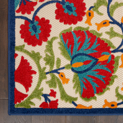 Colorful floral rug with red, blue, green flowers and orange accents on cream background, dark blue border, woven texture.