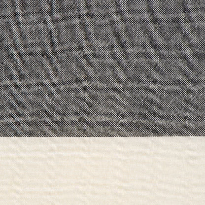 Two-tone woven fabric swatch: dark charcoal upper panel and light beige lower panel with fine texture.