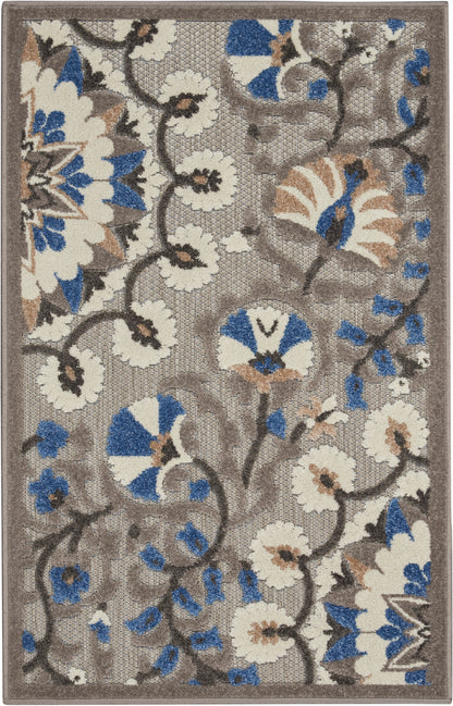 Rectangular beige-brown area rug with cream flowers & blue accents, dark vines in a floral motif; woven texture.