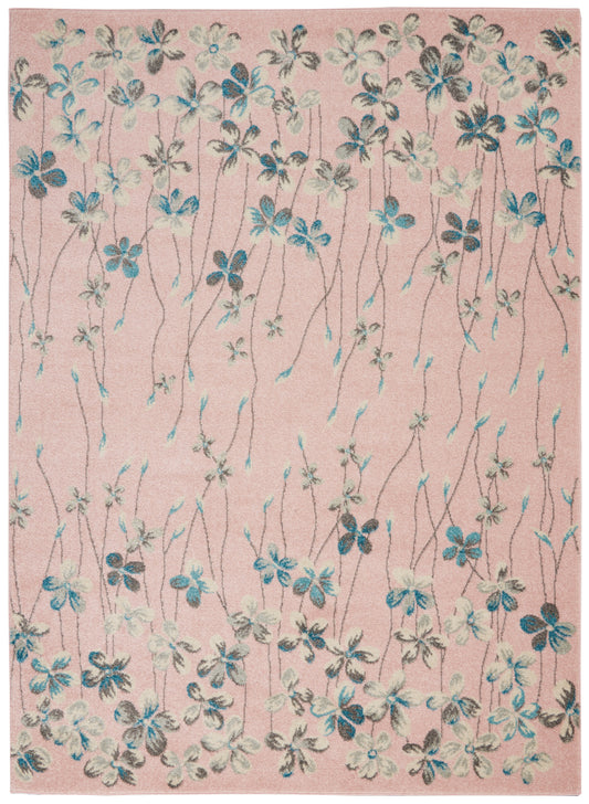 Pink floral rug with blue and cream blossoms on slender gray-brown stems; soft textured pile.
