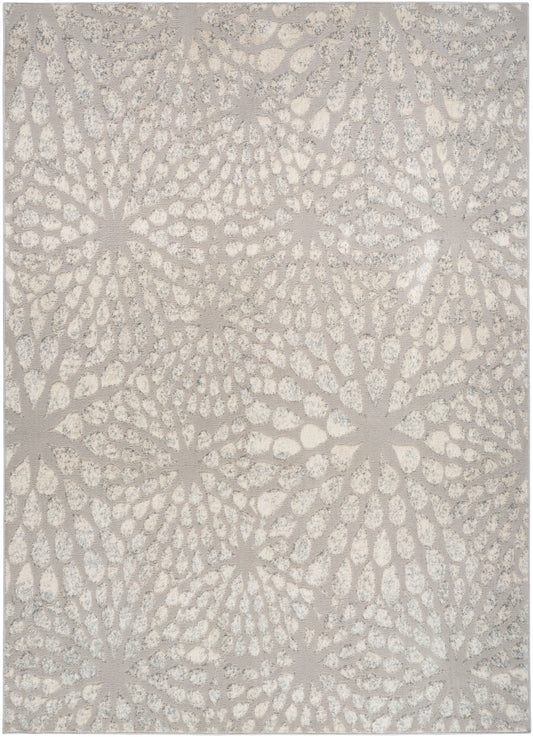 Textured ivory area rug with subtle beige circular starburst floral pattern; soft, woven look.