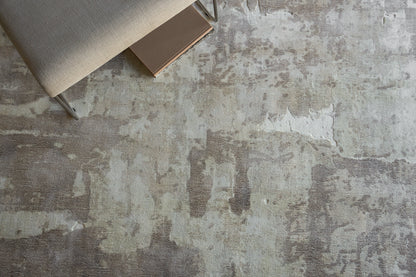 Beige indoor hand loomed rug, 4' x 6', on a weathered gray floor.