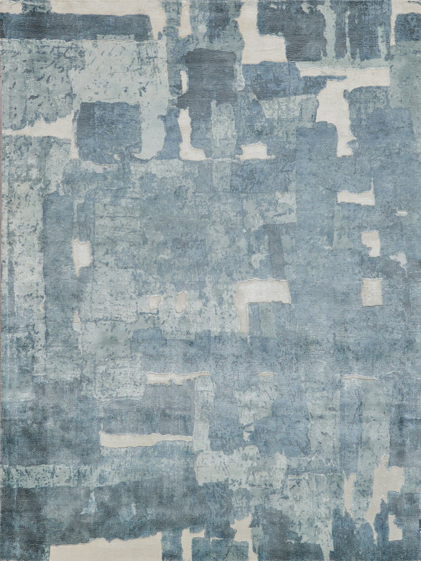Rectangular abstract blue-gray rug with washed patchwork blocks; modern contemporary decor.
