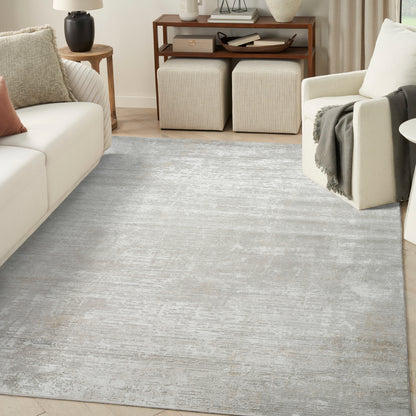 Soft gray distressed area rug in a modern living room with cream sofa, beige ottomans & wooden console table.