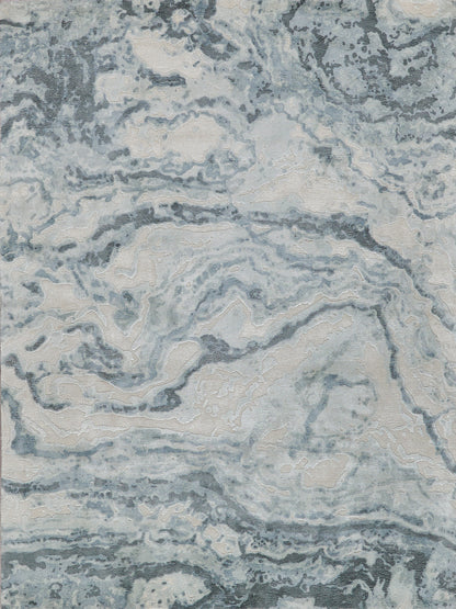 Abstract marble-pattern area rug in cool blues, grays and beige; plush, modern home decor.