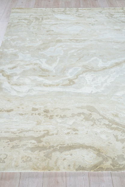 Cream marbled area rug with pale beige swirls on light wood floor
