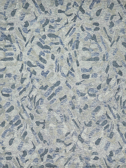 Abstract blue-gray rug with elongated brushstroke shapes; textured hand-tufted surface.