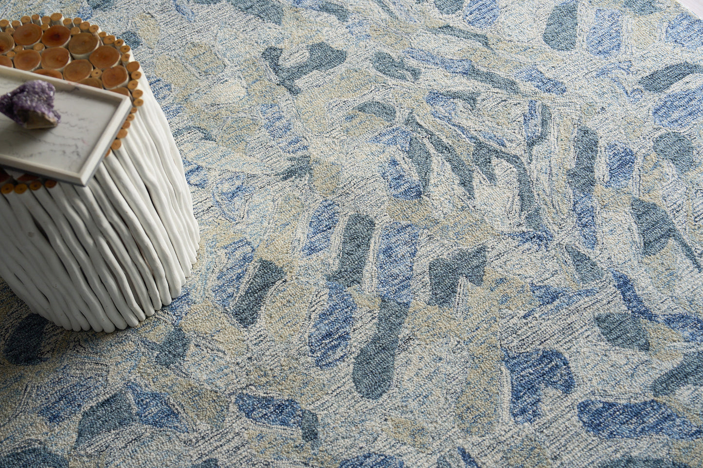 Blue & beige abstract area rug with textured pile; white ribbed round side table & marble tray & amethyst cluster.