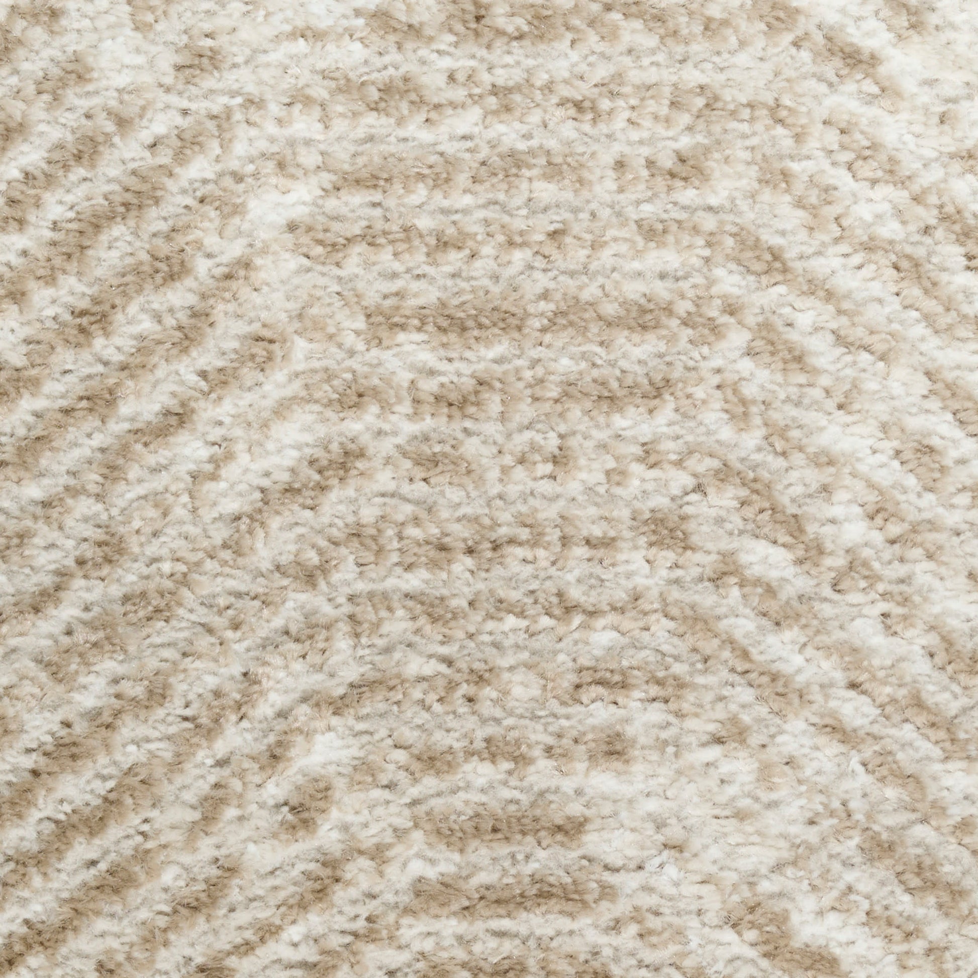 Beige plush shag rug with soft, fluffy pile and subtle wavy chevron pattern.