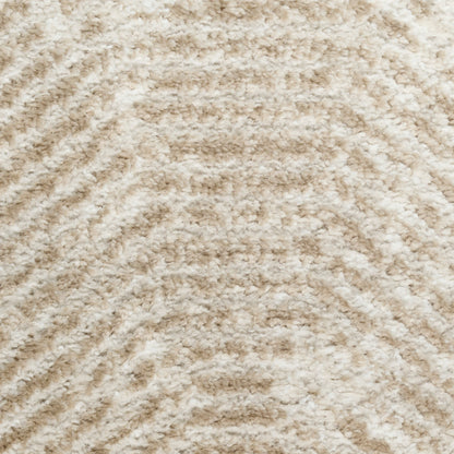 Beige plush shag rug with soft, fluffy pile and subtle wavy chevron pattern.