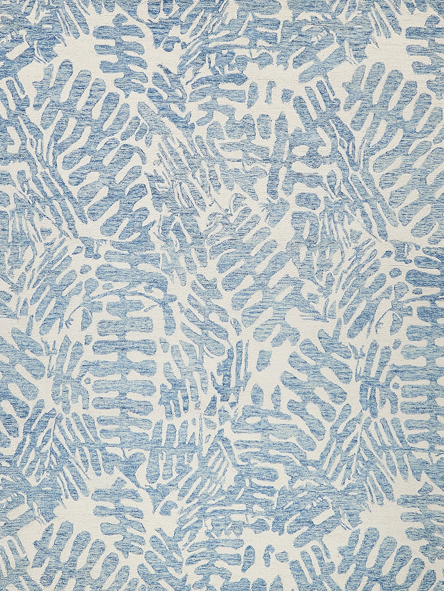 Blue and white abstract rug pattern with brush-like irregular shapes; indoor hand-tufted rug.
