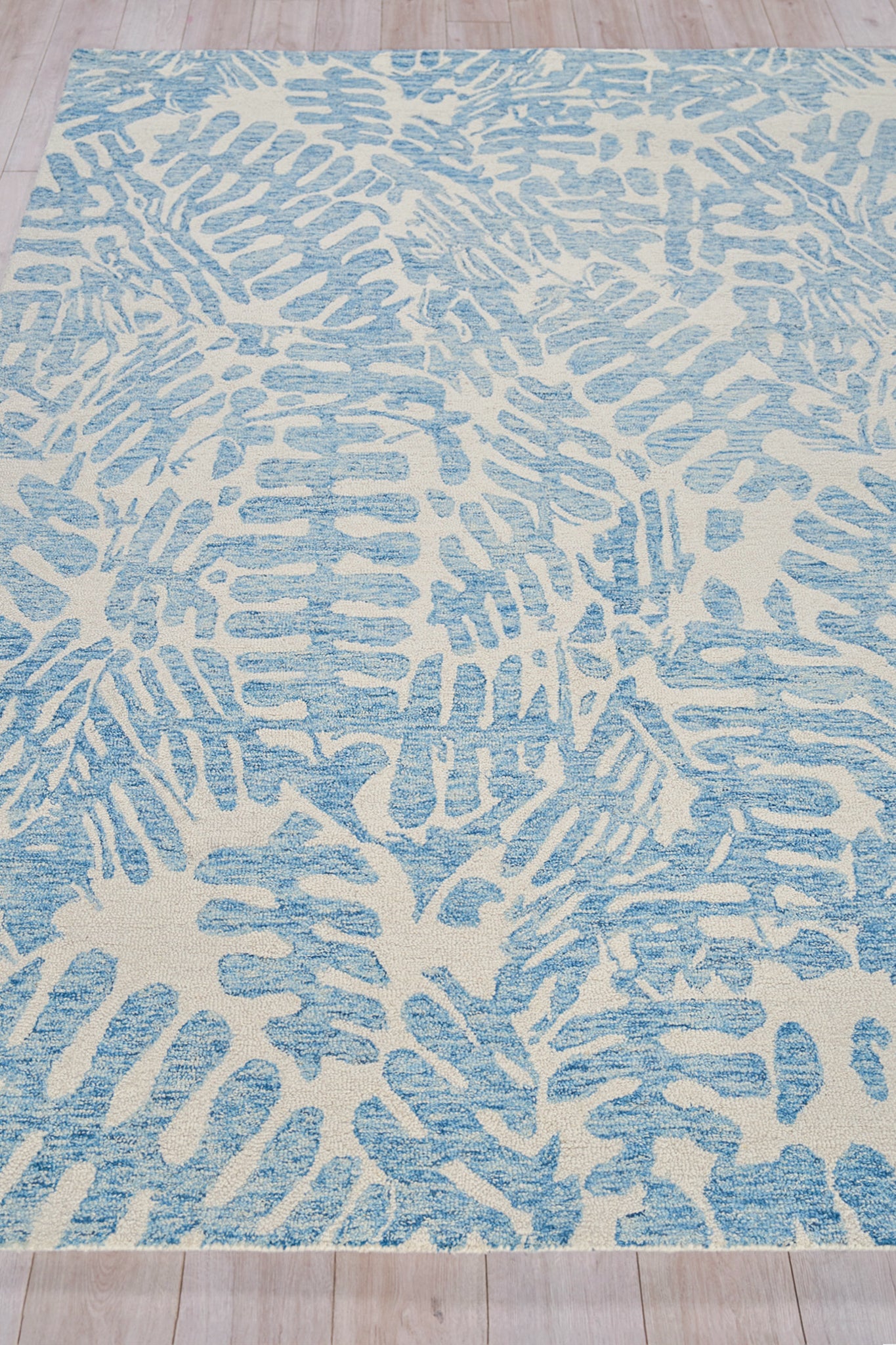 Blue and ivory abstract rug with elongated brushstroke patterns across the surface.