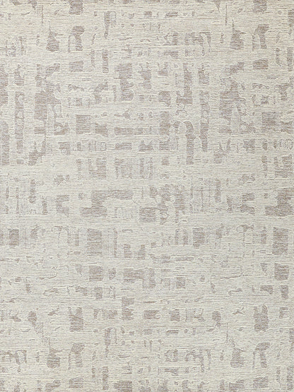 Neutral beige abstract-patterned area rug with a textured pile and taupe motifs.