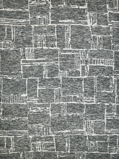Gray patchwork rug with distressed white rectangular grid in a modern, textured design.