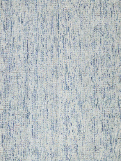 Blue and white distressed tufted rug with a soft linen-like texture and mottled pattern.