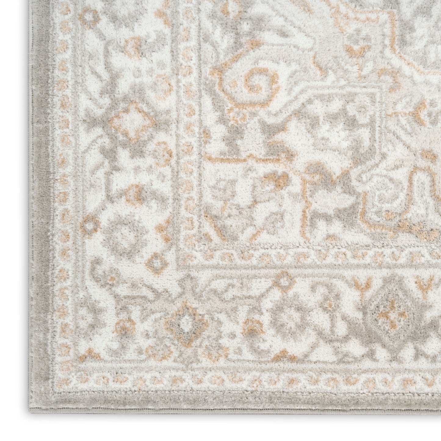 Light gray & ivory oriental-style rug corner with beige accents & ornate border.
