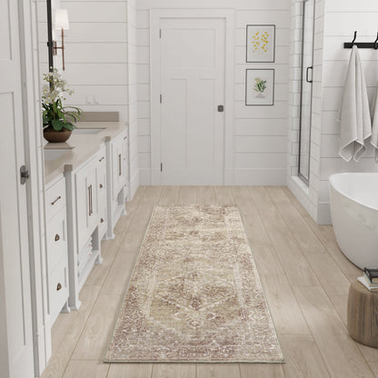 Long beige patterned runner rug on light wood floor in a bathroom with vanity, plant, framed art, glass shower, and tub.