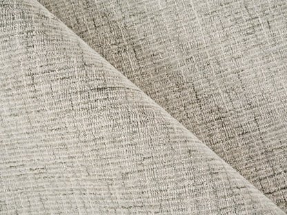 Beige textured woven rug, folded diagonally to show its soft, durable material.