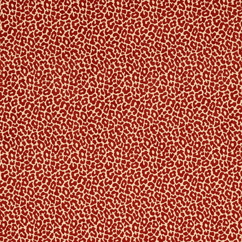 Red leopard print fabric on tan background; bold animal pattern for clothing or accessories.