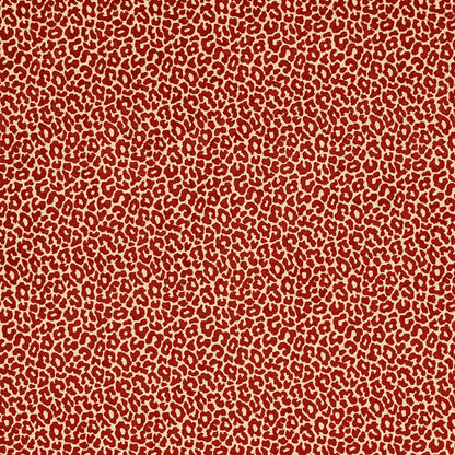 Red leopard print fabric on tan background; bold animal pattern for clothing or accessories.
