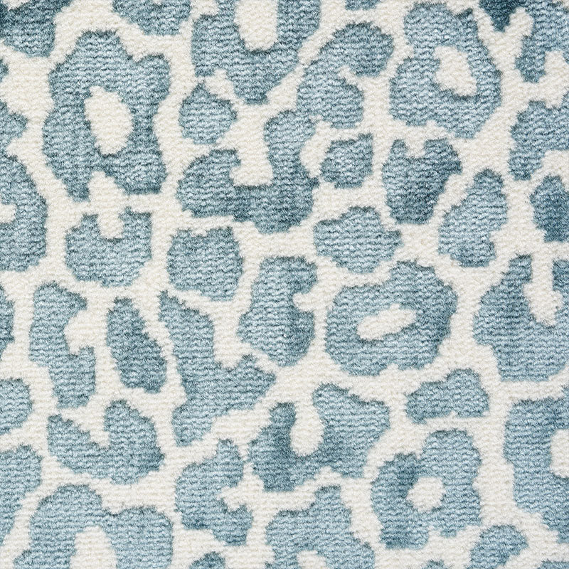 Blue leopard-print plush rug with white background; decorative floor covering.