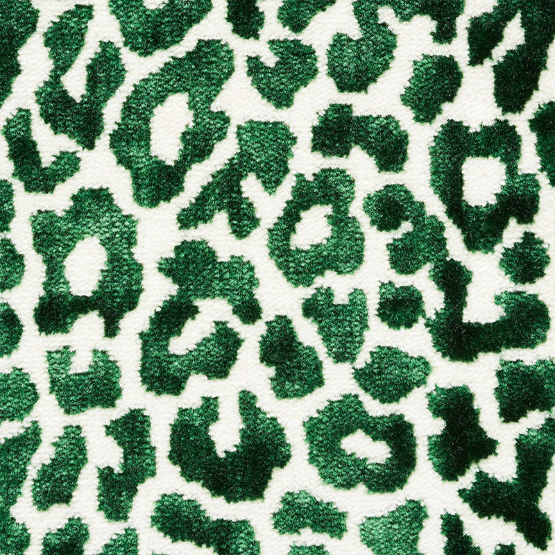 Emerald green leopard print plush fabric on white base with a bold textured pattern.
