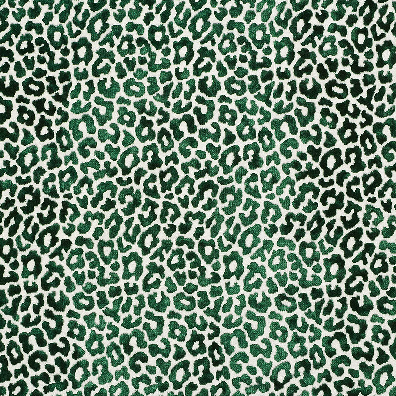 Emerald-green leopard print fabric with dark green spots on a cream background, bold animal pattern.